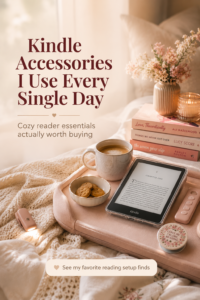 Cozy Pinterest-style reading setup on a cream textured bed featuring a Kindle Paperwhite with a clear glitter case, pink Kindle accessories, a glowing book light, ceramic coffee mug, snacks, and stacked romance books in soft natural morning light. Feminine neutral aesthetic with warm blush tones and overlay text reading “Kindle Accessories I Use Every Single Day” and “Cozy reader essentials actually worth buying.”